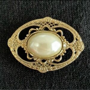 Victorian style gold tone and faux pearl brooch.  Pretty detailing. Like new.